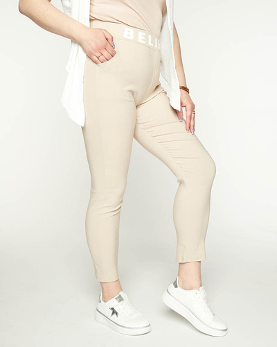 Beżowe damskie spodnie materiałowe z napisem PLUS SIZE - Odzież